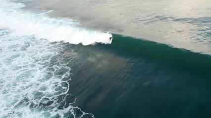 Surfing epic big huge ocean wave in tropical bali island Indonesia , professional surf in Uluwatu beach 