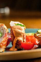 Fried pork rolls stuffed with prunes, wrapped in bacon,