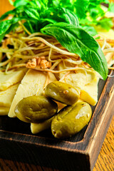 rye bruschetta with honey pumpkin and goat cheese on a dark wood background. tinting. selective focus on mint on the front bruschetta