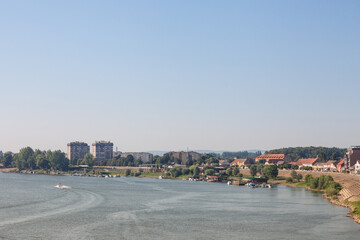 Aerial panorama of the Reka Sava river with the watefront quay in the left and a few boats passing by in Sremska Mitrovica, a city of Vojvodina, in the srem region, in Serbia. 