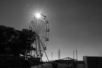 White ferris wheel on blue sky background in sunny day