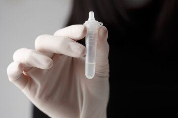 Asian women using Rapid Antigen Test Kit (ATK) by herself