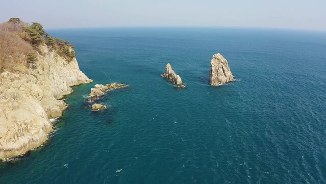 Kekura and rocky Cape Telyakovsky washed by the Sea of Japan on a sunny day