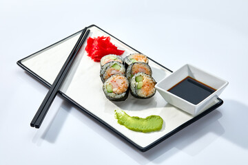 Sushi rolls and chopsticks on white background, space for text. Japanese food