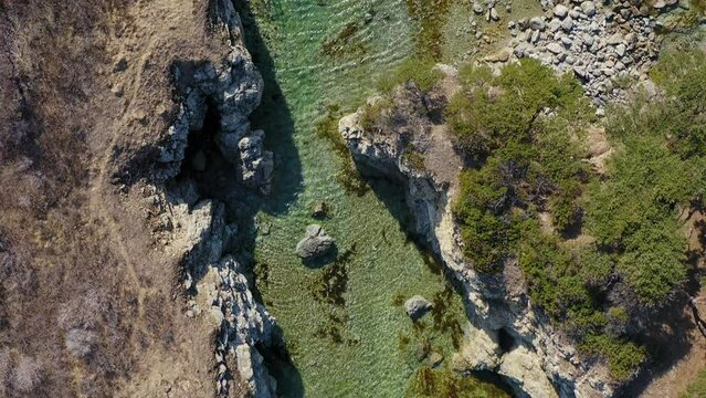 Rocky promontory with a strait between the rocks. Untouched nature. Drone view