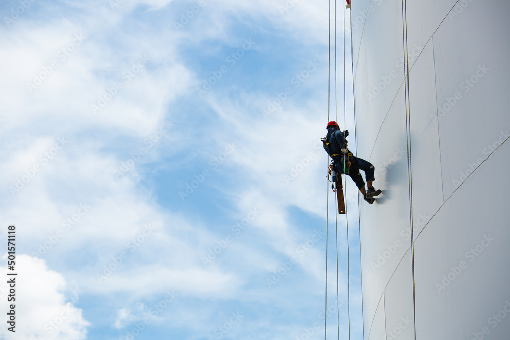 Wall mural male workers down height tank rope access inspection of thickness shell plate storage tank.