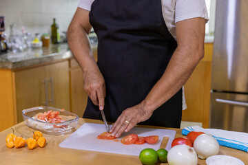 close up of man's hands cutting vegetables.