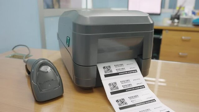 The black barcode printer is printing the bar code or QR code on the sticker.