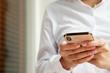 close up hand young woman in watching message on mobile smart phone during break. using cell phones to communicate in the online world. with blank or empty black screen