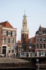 Naklejka premium city scape with church tower at Haarlem, the netherlands. Historic city centre without people. Romantic location tourist destination. Traditional dutch buildings. Culture background.