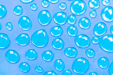 Fototapeta na wymiar Gel blue drops forming a background. The concept of protection against viruses or cosmetics. The perfect backdrop for a presentation