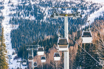 View of the gondola cable car in sunny winter weather. Winter ski resort background