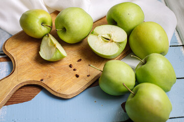 Fresh raw green apples on the wooden background. Healthy food. Juicy fruits for all