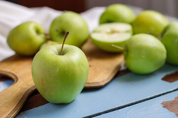 Fresh raw green apples on the wooden background. Healthy food. Juicy fruits for all