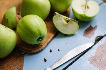 Fresh raw green apples on the wooden background. Healthy food. Juicy fruits for all