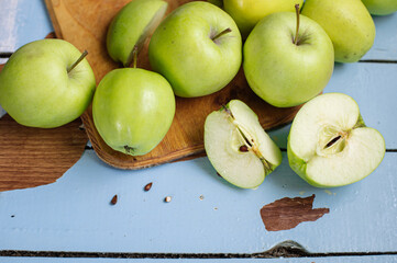 Fresh raw green apples on the wooden background. Healthy food. Juicy fruits for all