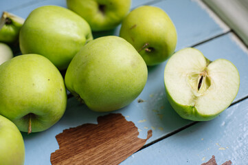 Fresh raw green apples on the wooden background. Healthy food. Juicy fruits for all
