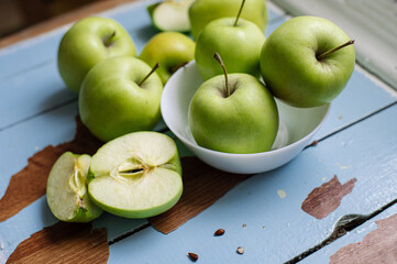 Fresh raw green apples on the wooden background. Healthy food. Juicy fruits for all
