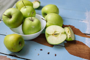 Fresh raw green apples on the wooden background. Healthy food. Juicy fruits for all