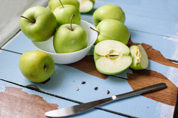 Fresh raw green apples on the wooden background. Healthy food. Juicy fruits for all