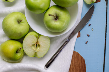 Fresh raw green apples on the wooden background. Healthy food. Juicy fruits for all