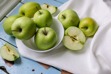 Fresh raw green apples on the wooden background. Healthy food. Juicy fruits for all