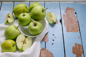 Fresh raw green apples on the wooden background. Healthy food. Juicy fruits for all