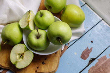 Fresh raw green apples on the wooden background. Healthy food. Juicy fruits for all