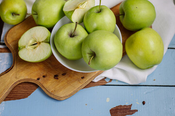 Fresh raw green apples on the wooden background. Healthy food. Juicy fruits for all