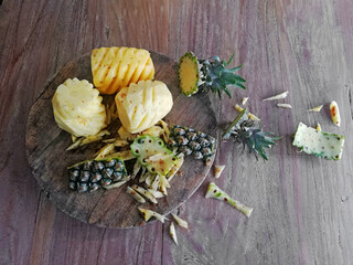 Cuted off,opened of pineapple,placed on brown wooden background