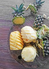 Cuted off,opened of pineapple,placed on brown wooden background