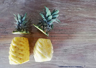 Cuted off,opened of pineapple,placed on brown wooden background