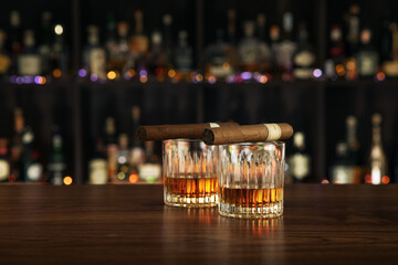 NO LOGOS OR TRADEMARKS!  SELF MADE LABELS!  Closed up view of glass of whiskey with cigars on top on color back - 501579917