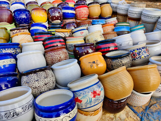 Picture of colorful flower pots out for sale shot on roadside