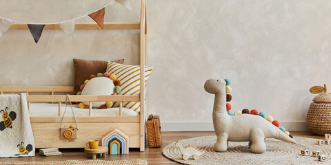 Stylish composition of cozy scandinavian child's room interior with wooden bed, pillows, plush...