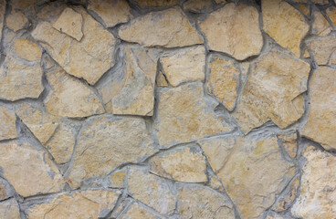 The texture of a stone wall. A stone wall as a background or texture.