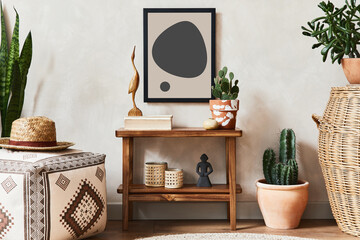Creative composition of stylish living room interior with mock up poster frame, wooden shelf, pouf, cacti and personal accessories. Plant love and nature concept. Template.