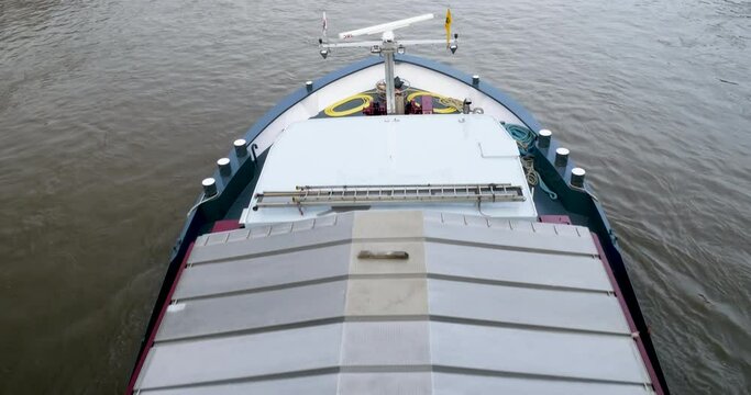 View from above of large taker with covered merchandise - transportation on large river