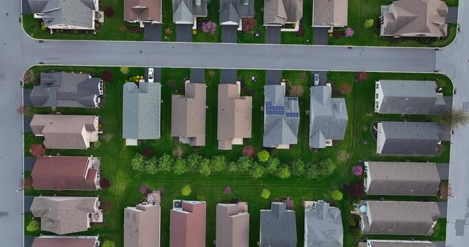 New compact housing in suburbs of USA. American urban population growth, sprawl concept. Top down aerial of rooftops.