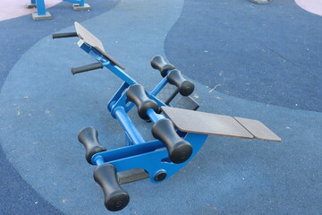 trainers and horizontal bars in city yard