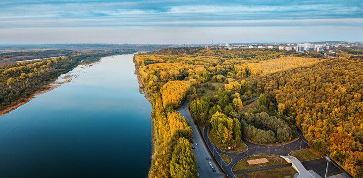 Aerial view of the picturesque autumn river in the suburbs of an industrial city