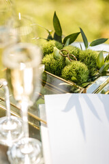 wedding rings are in a glass box next to two glasses of champagne