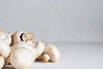 Fresh white mushrooms champignons on the table. Copy space