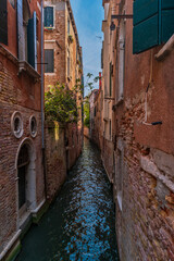 Fototapeta na wymiar View of street with quiet narrow canal. The residential area of Venice, Italy.
