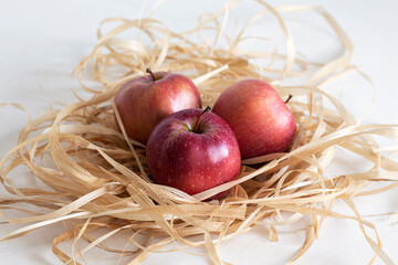 Ripe sweet tasty red apples on a straw