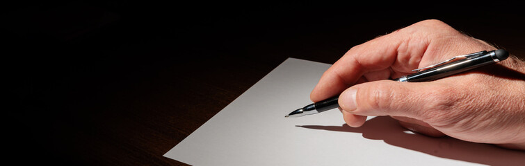 Banner with the hand writes on white paper with a pen. Hand signing a document