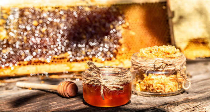 Natural honey with a spoon on old rustic table. bee products by organic natural ingredients concept, closeup