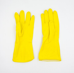 a pair of protective yellow household rubber gloves isolated