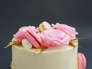  Cake with pink roses. Sweet confection with white cream and decorated flowers. Pastry on a light grey background. Dessert for birthday, for Valentine's day, for Mother's day, wedding.