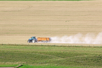 Tractor working Fields of the Pewsey Vale, Wiltshire at harvest	